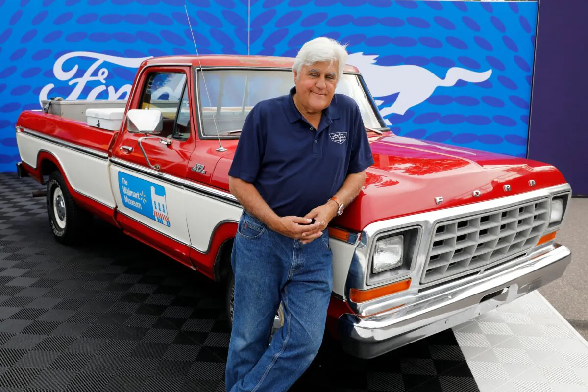 Comedian Jay Leno poses in front of a 1979 Ford F-150 pickup, in the style of one owned by Walmart founder Sam Walton during the 27th annual Woodward Dream Cruise, in Royal Oak, Mich., on Aug. 20, 2022. (Jeff Kowalsky/AFP via Getty Images)