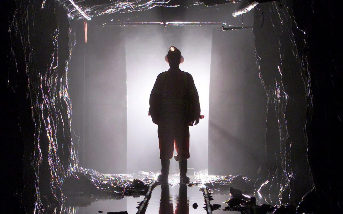 A miner is silhouetted as he passes through a doorway in a mine shaft 100 feet below the surface. Migrant workers, such as in HD Mining’s controversial decision to hire some 200 Chinese miners to work in B.C., are filling the majority of new jobs created in Canada in recent years, a new study has found. (Adrian Wyld/The Canadian Press)