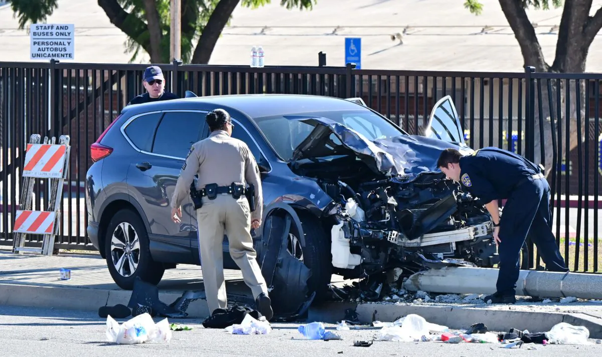 Law enforcement personnel take a closer look at the destruction of an SUV involved in critically injuring nearly two dozen deputy recruits in a Los Angeles County Sheriff's Department training academy class in Whittier, Calif., on Nov. 16, 2022. (Frederic J. Brown/AFP via Getty Images)