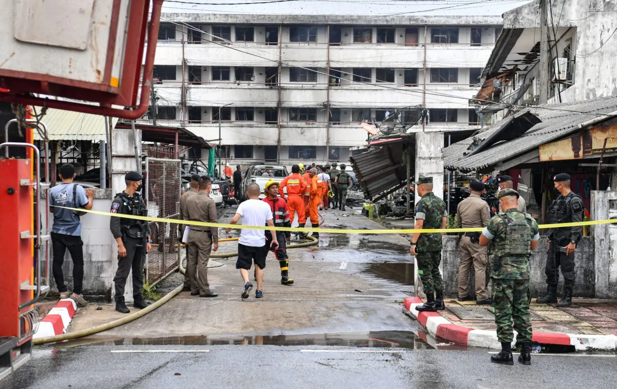 Police officials and rescue workers intervene after a car bomb exploded outside a police accommodation in Narathiwat town, southern Thailand, on Nov. 22, 2022. (Madaree Tholala/AFP via Getty Images)