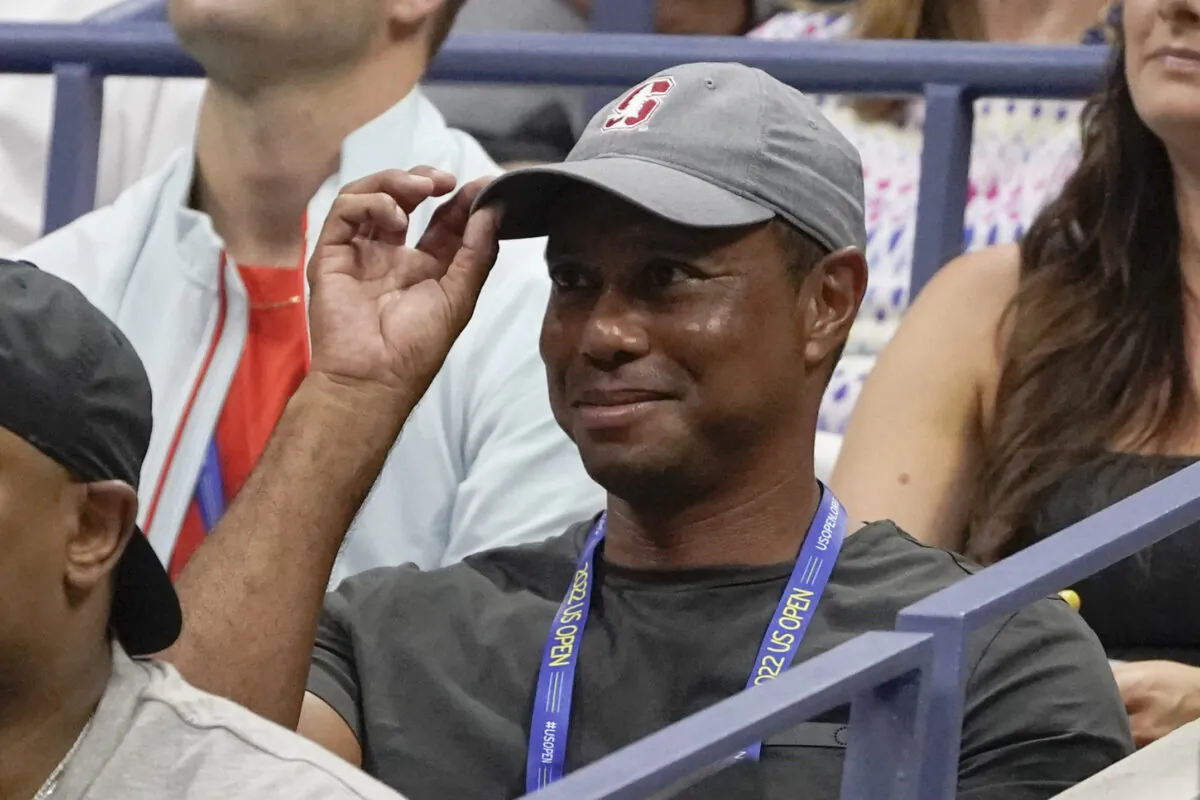 Tiger Woods tips his hat to the crowd during a match between Serena Williams of the United States and Anett Kontaveit of Estonia in the second round of the U.S. Open tennis championships in New York on Aug. 31, 2022. (John Minchillo/AP Photo)