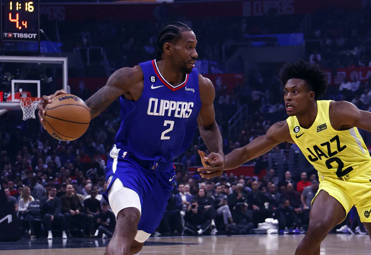 Kawhi Leonard (2) of the LA Clippers controls the ball against Collin Sexton (2) of the Utah Jazz in the first half at Crypto.com Arena in Los Angeles on Nov. 21, 2022. (Ronald Martinez/Getty Images)