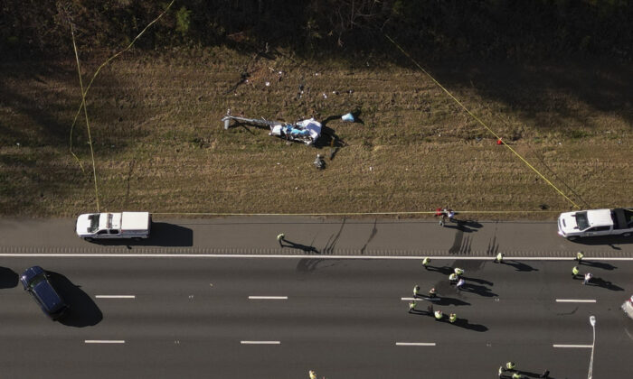 Emergency unit   enactment    astatine  the country   of a chopper  clang  connected  the broadside  of Interstate 77 South successful  Charlotte, N.C., connected  Nov. 22, 2022. (Alex Slitz/The Charlotte Observer via AP)