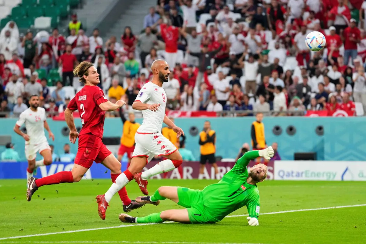 (L–R) Denmark's Joachim Andersen, Tunisia's Issam Jebali, and Denmark's goalkeeper Kasper Schmeichel in action during the World Cup group D soccer match between Denmark and Tunisia, at the Education City Stadium in Al Rayyan, Qatar, on Nov. 22, 2022. (Petr David Josek/AP Photo)