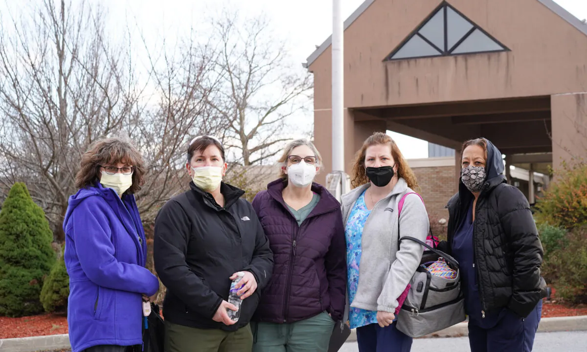 Nurses Doreen Tice (2nd from left) and Kathleen McGinnis (Center) with colleagues in front of the main entrance of Valley View Center for Nursing Care and Rehabilitation in Goshen, N.Y., on Nov. 18, 2022. (Cara Ding/The Epoch Times)