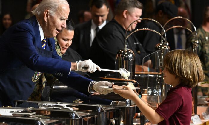 President Joe Biden serves food to military families during a "Friendsgiving" celebration in honor of the upcoming Thanksgiving holiday at the Marine Corps Air Station in Cherry Point, North Carolina, on Nov. 21, 2022. (Jim Watson/Getty Images)