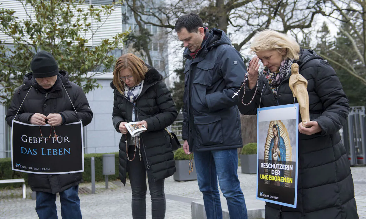 Pro-life activists pray while they take part in the campaign "40 Days for Life" outside the Pro Familia center, which offers consultations on abortions, in Frankfurt, Germany, on March 26, 2019. (Thomas Lohnes/Getty Images) 