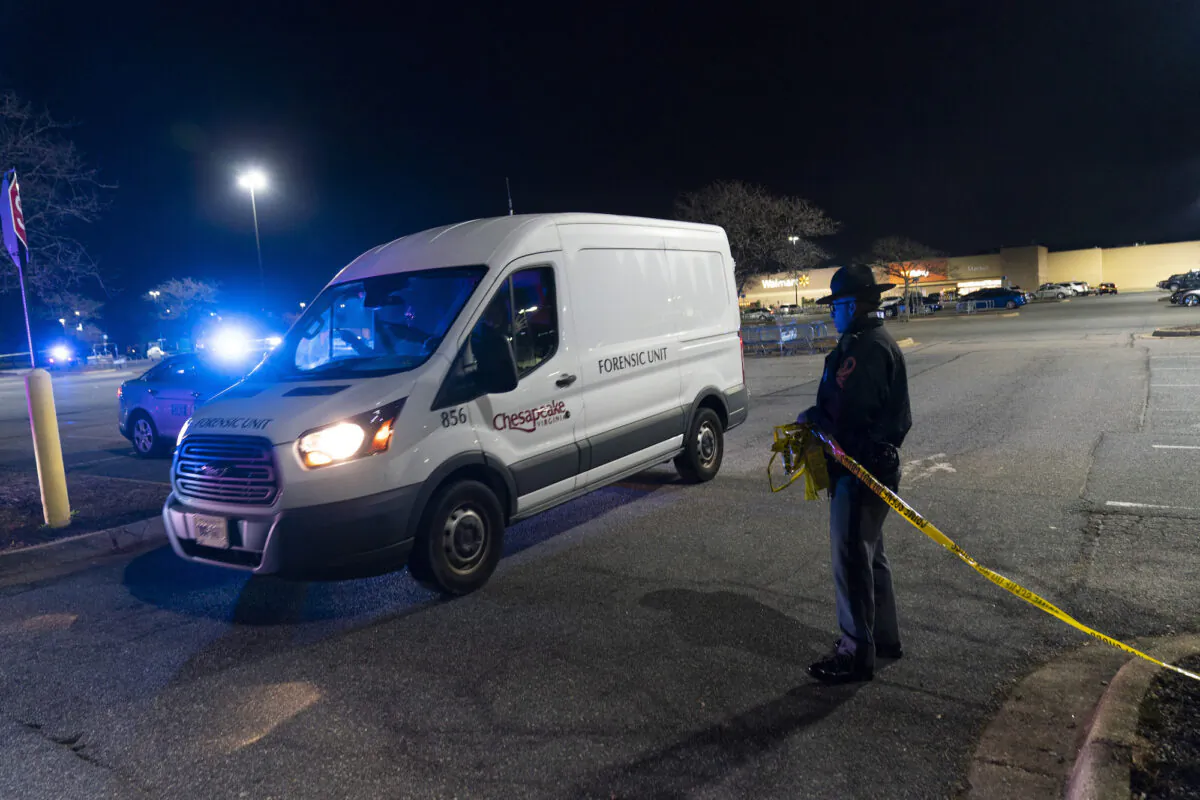 A forensics van leaves as law enforcement work at the scene of a mass shooting at a Walmart, on Nov. 23, 2022, in Chesapeake, Va. (AP Photo/Alex Brandon)