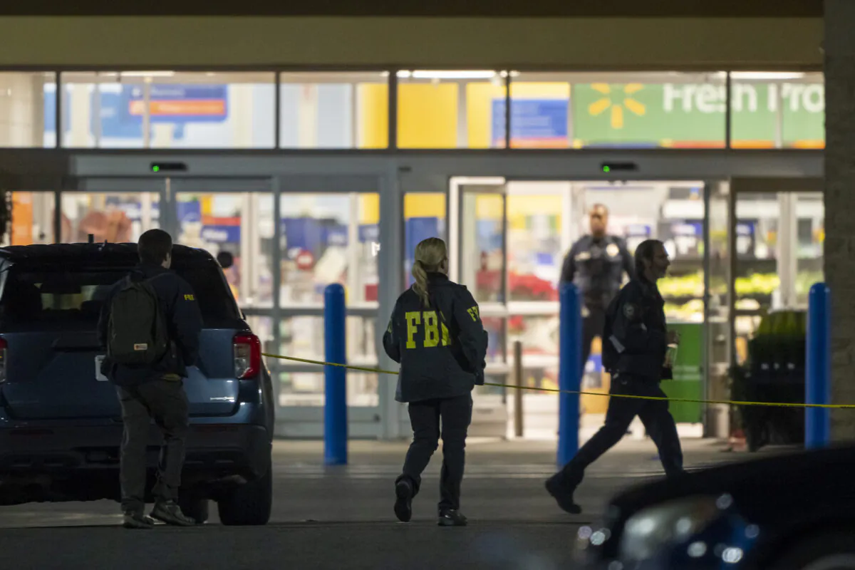 Law enforcement, including the FBI, work the scene of a mass shooting at a Walmart, on Nov. 23, 2022, in Chesapeake, Va. (AP Photo/Alex Brandon)