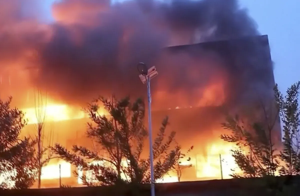 An industrial wholesaler burns in Anyang in central China's Henan province, on Nov. 21, 2022, in a still from video. (CCTV via AP)