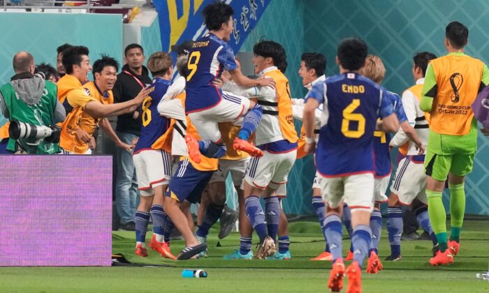 Japan players celebrate after Takuma Asano scored his side's second goal during the World Cup group E soccer match between Germany and Japan, at the Khalifa International Stadium in Doha, Qatar, on Nov. 23, 2022. (Eugene Hoshiko/AP Photo)