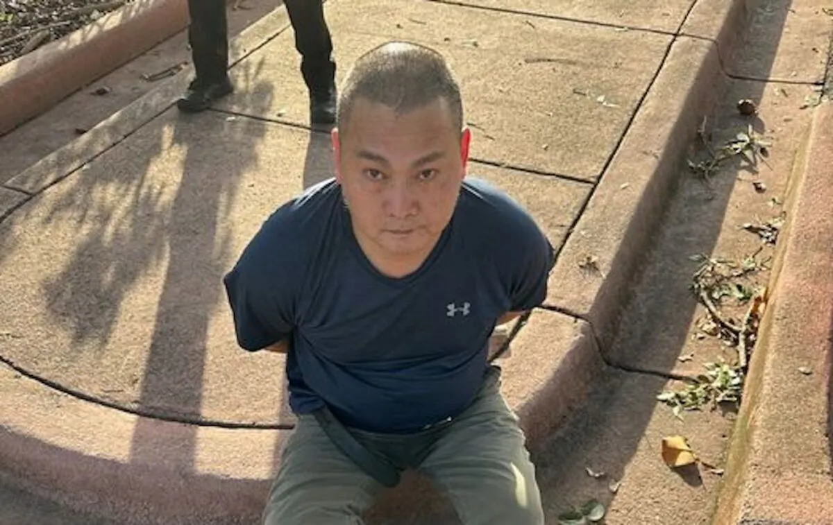 Murder suspect Wu Chen following his arrest in Florida on Nov. 22, 2022.  Chen is wanted in connection with a quadruple homicide in Oklahoma. (U.S. Marshals)