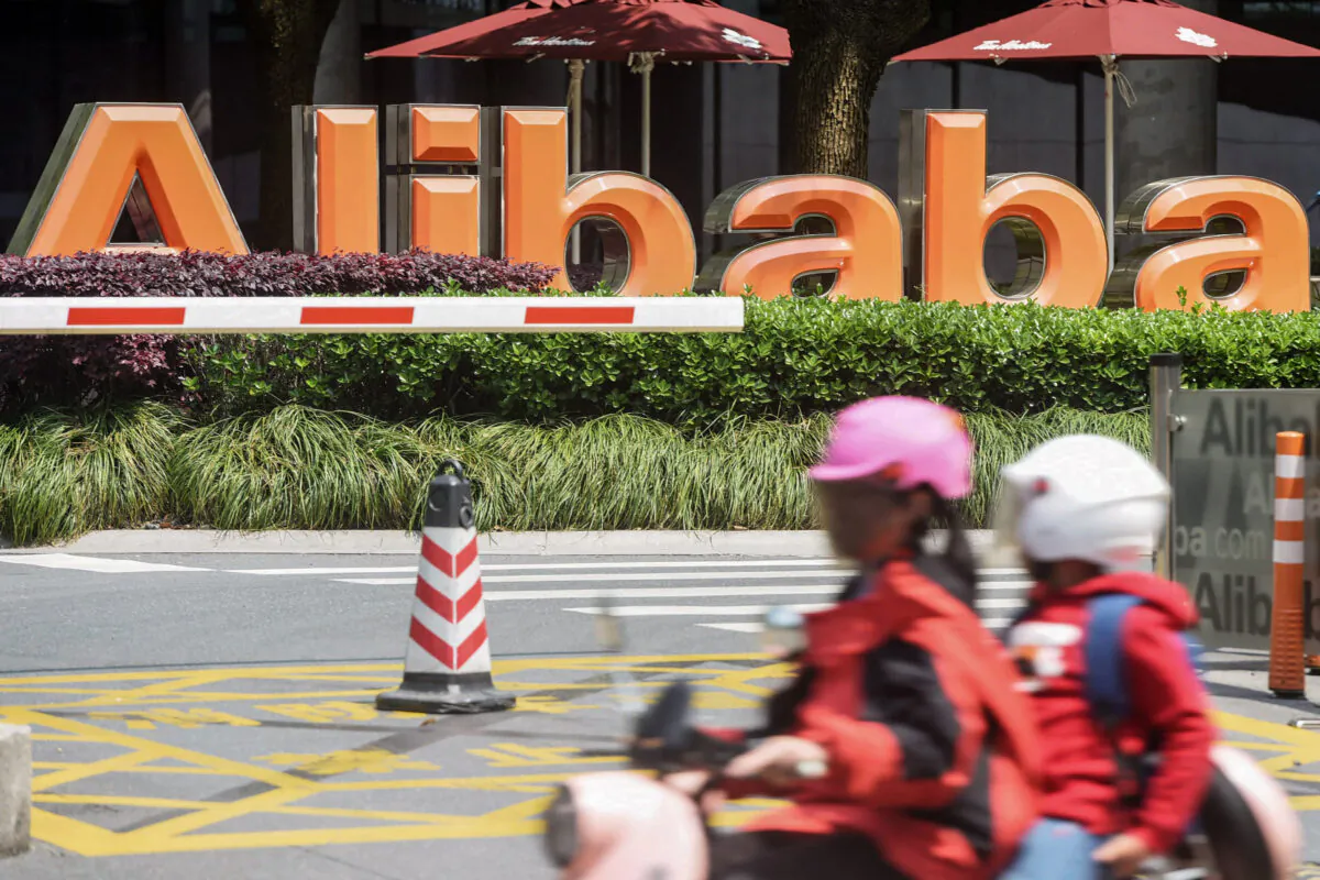 People commute past Chinese e-commerce giant Alibaba's headquarters in Hangzhou in China's eastern Zhejiang province on May 26, 2022. (STR/AFP via Getty Images)