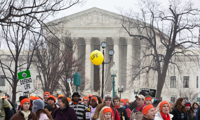 Pro-life activists stand near the U.S. Supreme Court in Washington on Jan. 23, 2012. (Brendan Hoffman/Getty Images)