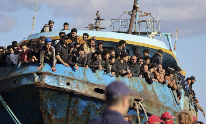 Migrants look   retired  of a sportfishing  vessel  docked astatine  the larboard  of Palaiochora successful  southeastern Crete, Greece connected  Nov. 22, 2022. (InTime News via AP)