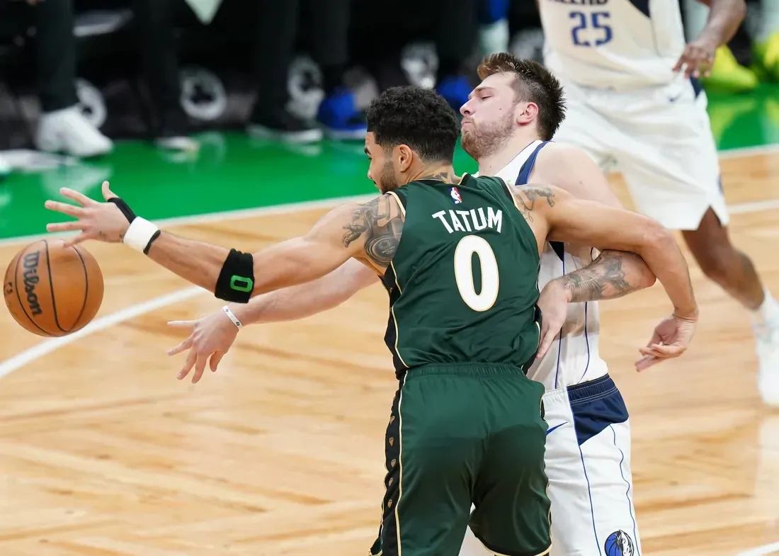 Dallas Mavericks guard Luka Doncic (77) works for the ball against Boston Celtics forward Jayson Tatum (0) in the fourth quarter at TD Garden in Boston on Nov. 23, 2022. (David Butler II/USA TODAY Sports via Field Level Media)