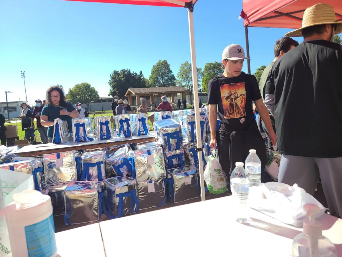 Volunteers prepare to hand out boxes of donated food for the Thanksgiving holiday at the local nonprofit Friends of Families' food distribution event in Stanton, Calif., on Nov. 19, 2022. (Courtesy of George Grachen)