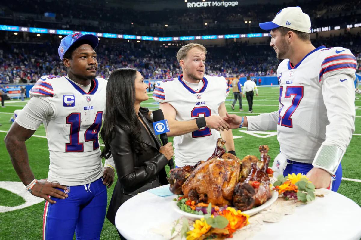 Stefon Diggs (14), Tyler Bass (2) and Josh Allen (17) of the Buffalo Bills celebrate on the field after defeating the Detroit Lions in Detroit, Mich., at Ford Field on Nov. 24, 2022. (Nic Antaya/Getty Images)