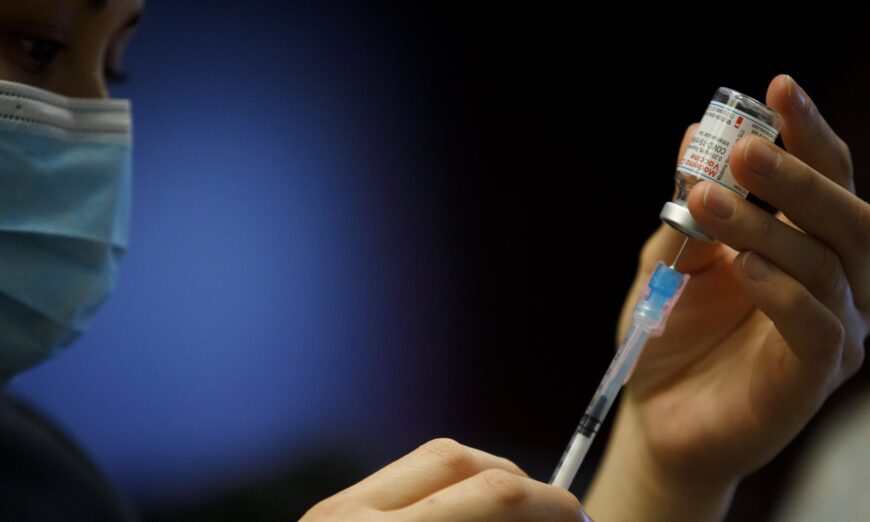 A nurse prepares a COVID-19 vaccine in Toronto, Canada, in a March 23, 2021, file photograph. (Cole Burston/Getty Images)