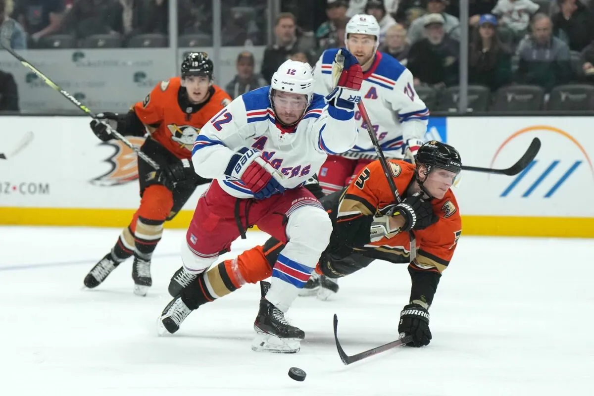New York Rangers right wing Julien Gauthier (12) and Anaheim Ducks defenseman John Klingberg (3) battle for the puck in the first period at Honda Center, in Anaheim, Calif., on Nov. 23, 2022. (Kirby Lee/USA TODAY Sports via Field Level Media)