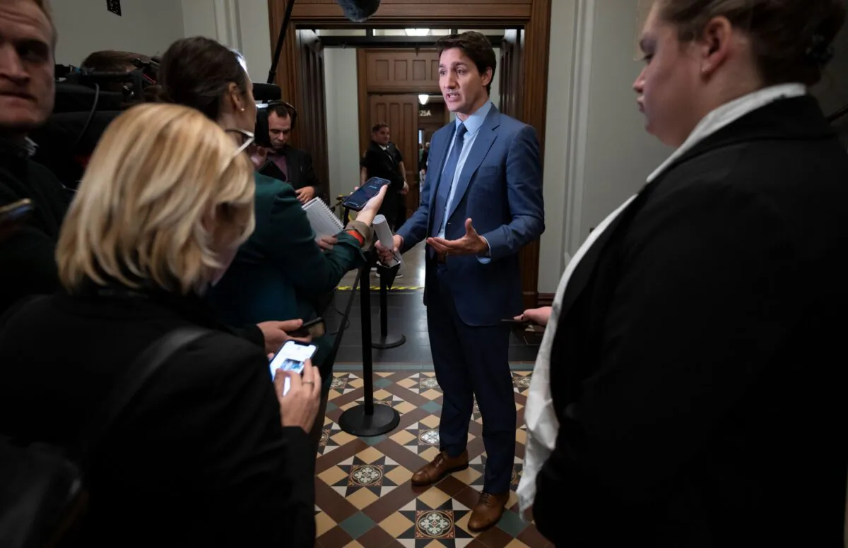 Prime Minister Justin Trudeau speaks with reporters as he makes his way to a caucus meeting in Ottawa on Nov. 23, 2022. (The Canadian Press/Adrian Wyld)