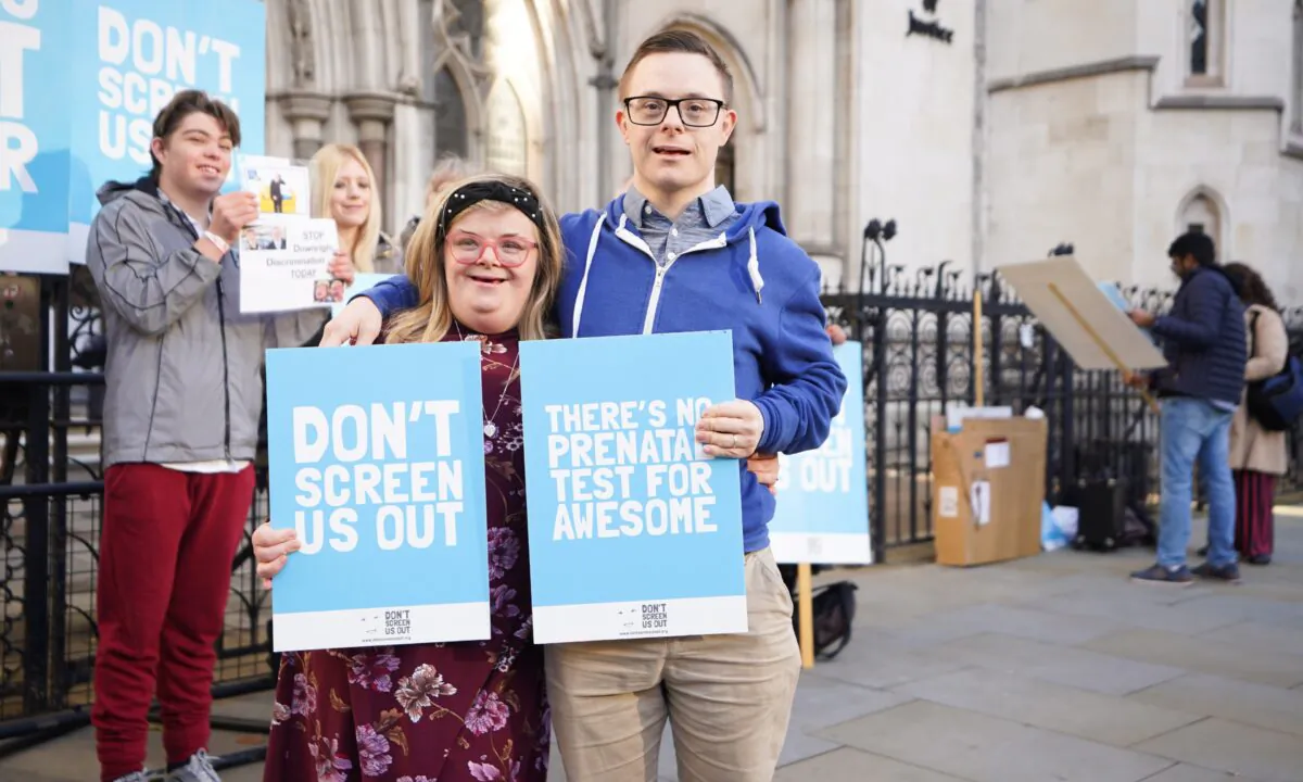 Heidi Crowter with her husband James Carter, outside the Royal Courts of Justice in central London, on Nov. 25, 2022. (James Manning/PA Media)