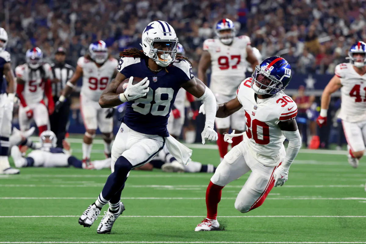 CeeDee Lamb (88) of the Dallas Cowboys runs the ball after a catch while defended by Darnay Holmes (30) of the New York Giants during the second half at AT&T Stadium in Arlington, Texas, on Nov. 24, 2022 (Richard Rodriguez/Getty Images)