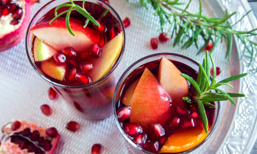 Christmas, autumn or winter drink with oranges, apples, pomegranate seeds, rosemary (Oksana Mizina/Shutterstock)