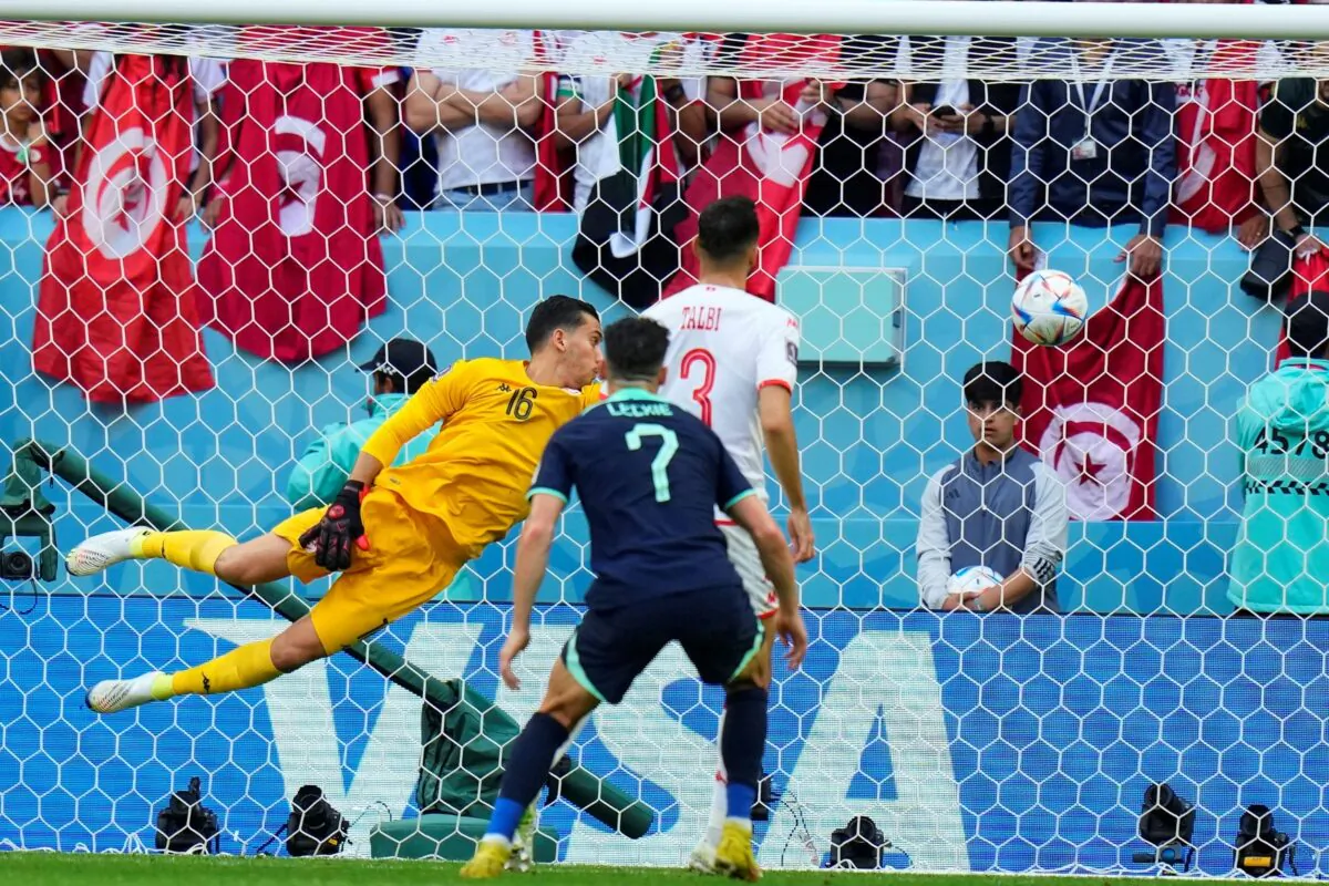 Tunisia's goalkeeper Aymen Dahmen fails to stop the ball as Australia's Mitchell Duke scores the opening goal of his team during the World Cup group D soccer match between Tunisia and Australia at the Al Janoub Stadium in Al Wakrah, Qatar, on Nov. 26, 2022. (Petr David Josek/AP Photo)