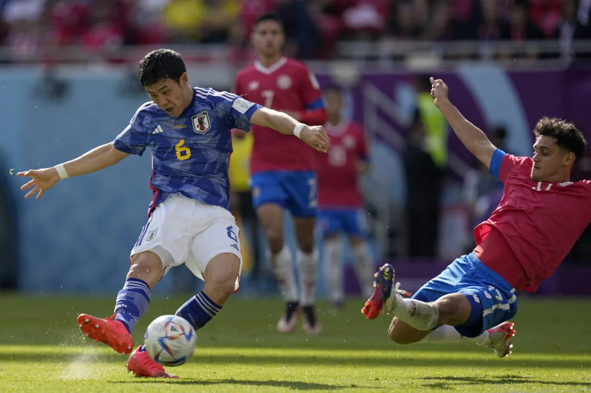 Costa Rica's Yeltsin Tejeda (R) tries to block a shot from Japan's Wataru Endo during the World Cup, group E soccer match between Japan and Costa Rica, at the Ahmad Bin Ali Stadium in Al Rayyan, Qatar, on Nov. 27, 2022. (Ariel Schalit/AP Photo)