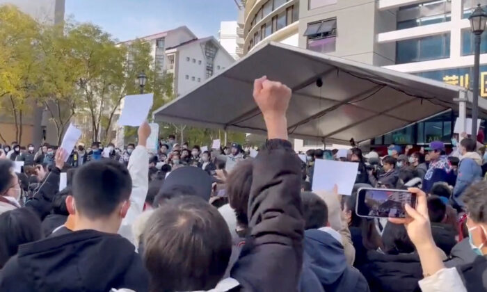 Students take part in a protest against COVID-19 curbs at Tsinghua University in Beijing, in a still from video released on Nov. 27, 2022. (Reuters)