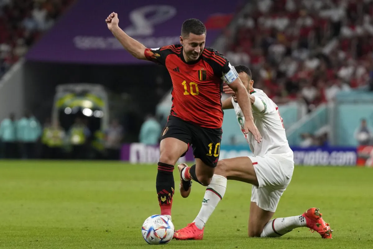 Morocco's Romain Saiss (R) fights for the ball with Belgium's Eden Hazard, during the World Cup group F soccer match between Belgium and Morocco, at the Al Thumama Stadium in Doha, Qatar, on Nov. 27, 2022. (Alessandra Tarantino/AP Photo)