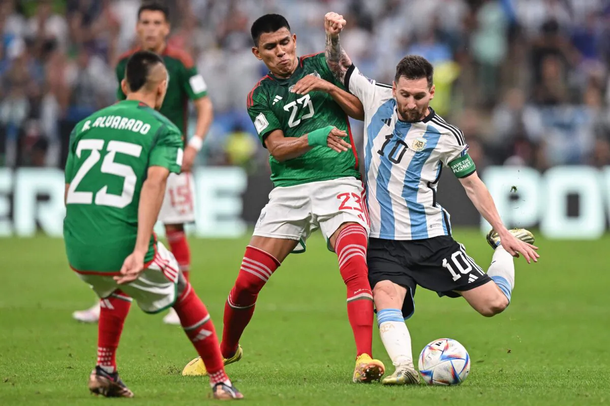 Argentina's forward (10) Lionel Messi (R) prepares for shot against Mexico's defender (23) Jesus Gallardo (C) during the Qatar 2022 World Cup Group C football match between Argentina and Mexico at the Lusail Stadium in Lusail, north of Doha on Nov. 26, 2022. (Glyn Kirk/AFP via Getty Images)