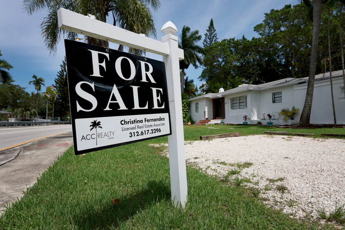 A 'For Sale' sign hangs in front of a home in Miami, Fla., on June 21, 2022. (Joe Raedle/Getty Images)