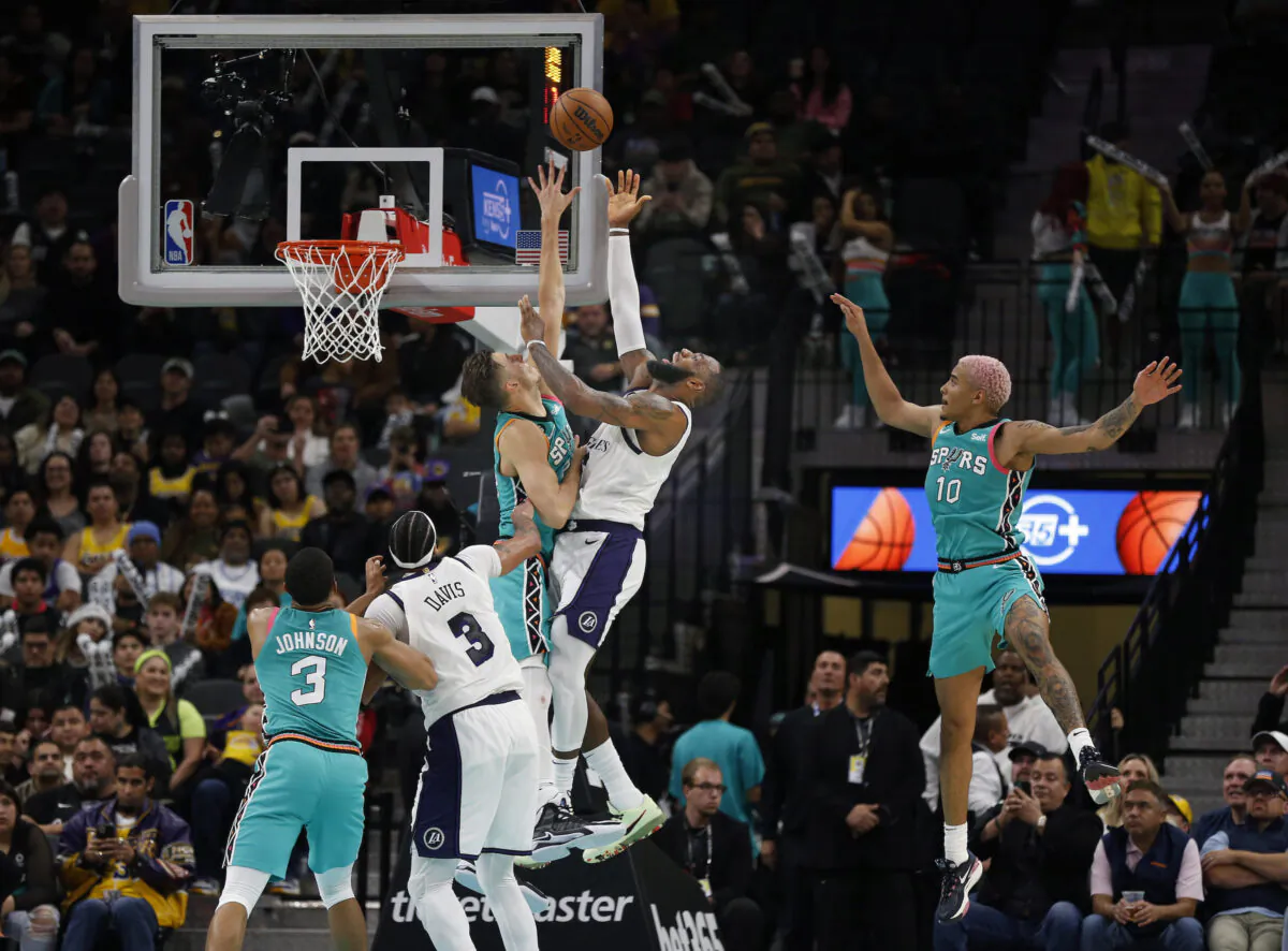 LeBron James (6) of the Los Angeles Lakers drives over Zach Collins (23) of the San Antonio Spurs in the second half at AT&T Center in San Antonio, Texas on November 25, 2022. (Ronald Cortes/Getty Images)