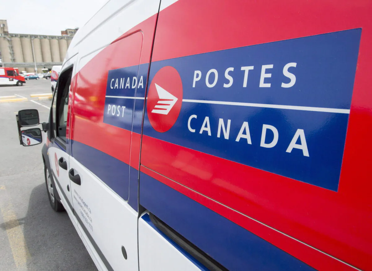 A Canada Post truck is parked at a sorting centre in Montreal on July 8, 2016. (Ryan Remiorz/The Canadian Press)