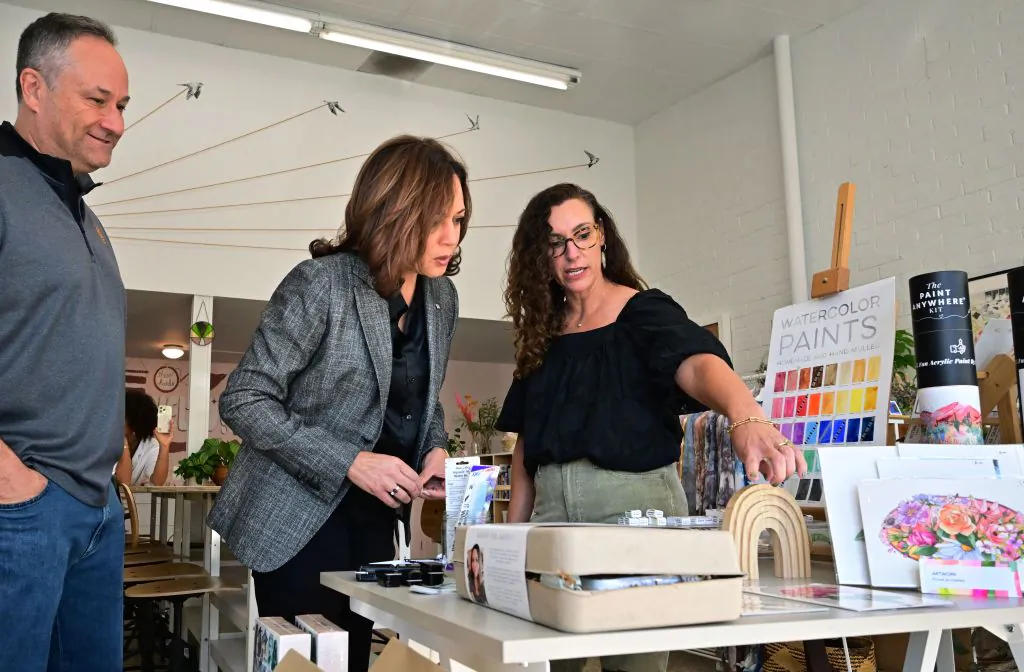 US Vice President Kamala Harris (C), with Second Gentleman Doug Emhoff (L) is shown around 'These Hands Collective,' a Latina-owned shared creative space by owner Denise Ambrosi in Los Angeles on Nov. 26, 2022. (Frederic J. Brown/AFP via Getty Images)