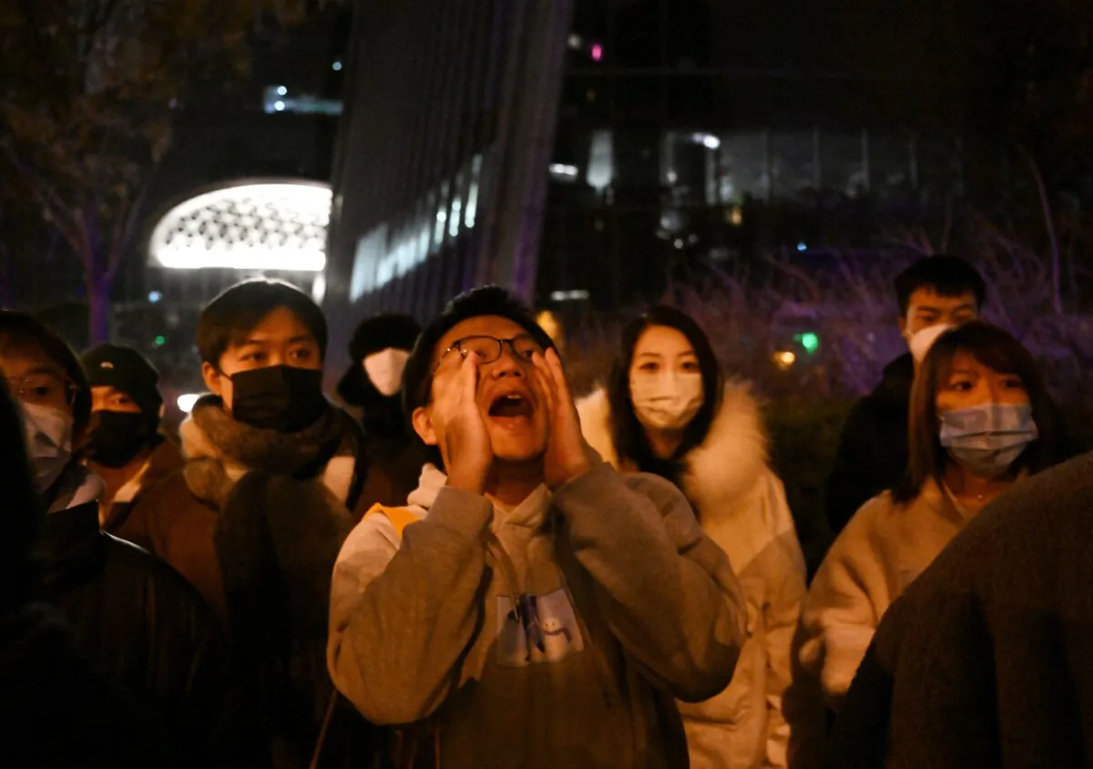 A protester shouts during a protest for the victims of a deadly fire as well as a protest against China's harsh COVID-19 restrictions in Beijing on Nov. 28, 2022. (Noel Celis/AFP via Getty Images)