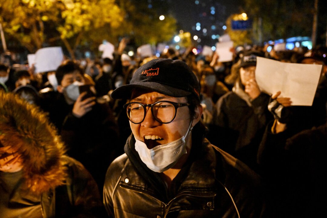 Protesters march against China's harsh Covid-19 restrictions in Beijing on November 28, 2022. (Photo by NOEL CELIS/AFP via Getty Images)