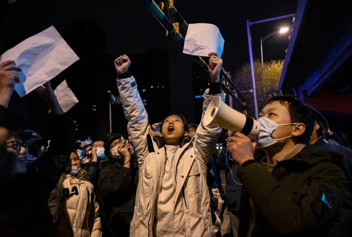 Protesters shout slogans during a protest against Chinas strict zero COVID measures in Beijing  on Nov. 28, 2022. (Kevin Frayer/Getty Images)