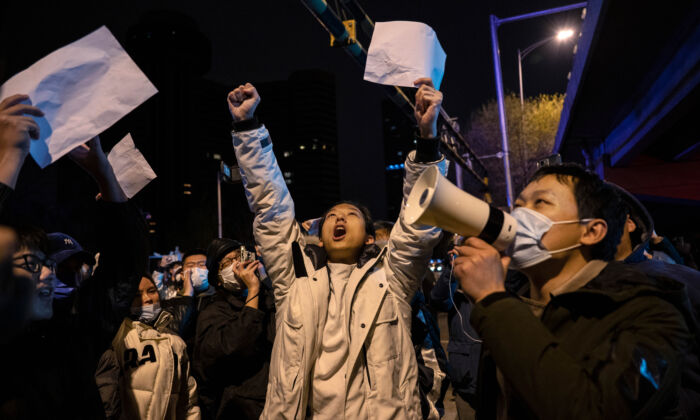 Protesters shout slogans during a protest against China's strict zero-COVID measures, in Beijing on Nov. 28, 2022. (Kevin Frayer/Getty Images)