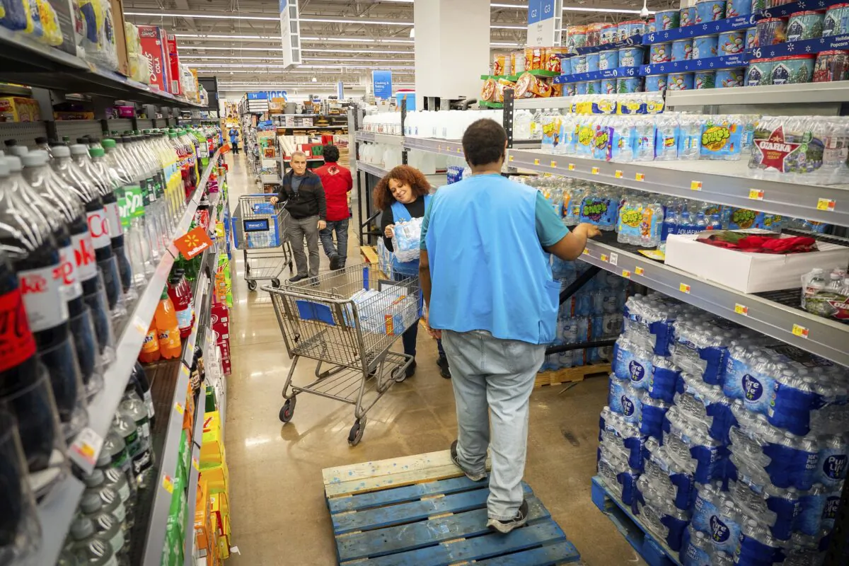 People shop for bottled water after a boil water notice was issued for the entire city of Houston at Walmart on S. Post Oak Rd. in Houston on Nov. 27, 2022. (Mark Mulligan/Houston Chronicle via AP)