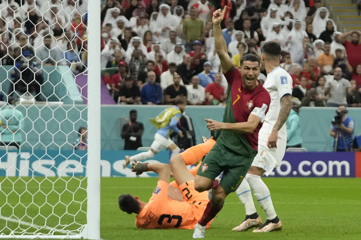 Portugal's Cristiano Ronaldo celebrates after scoring his side's opening goal during the World Cup group H soccer match between Portugal and Uruguay, at the Lusail Stadium in Lusail, Qatar, on Nov. 28, 2022. (Themba Hadebe/AP Photo)