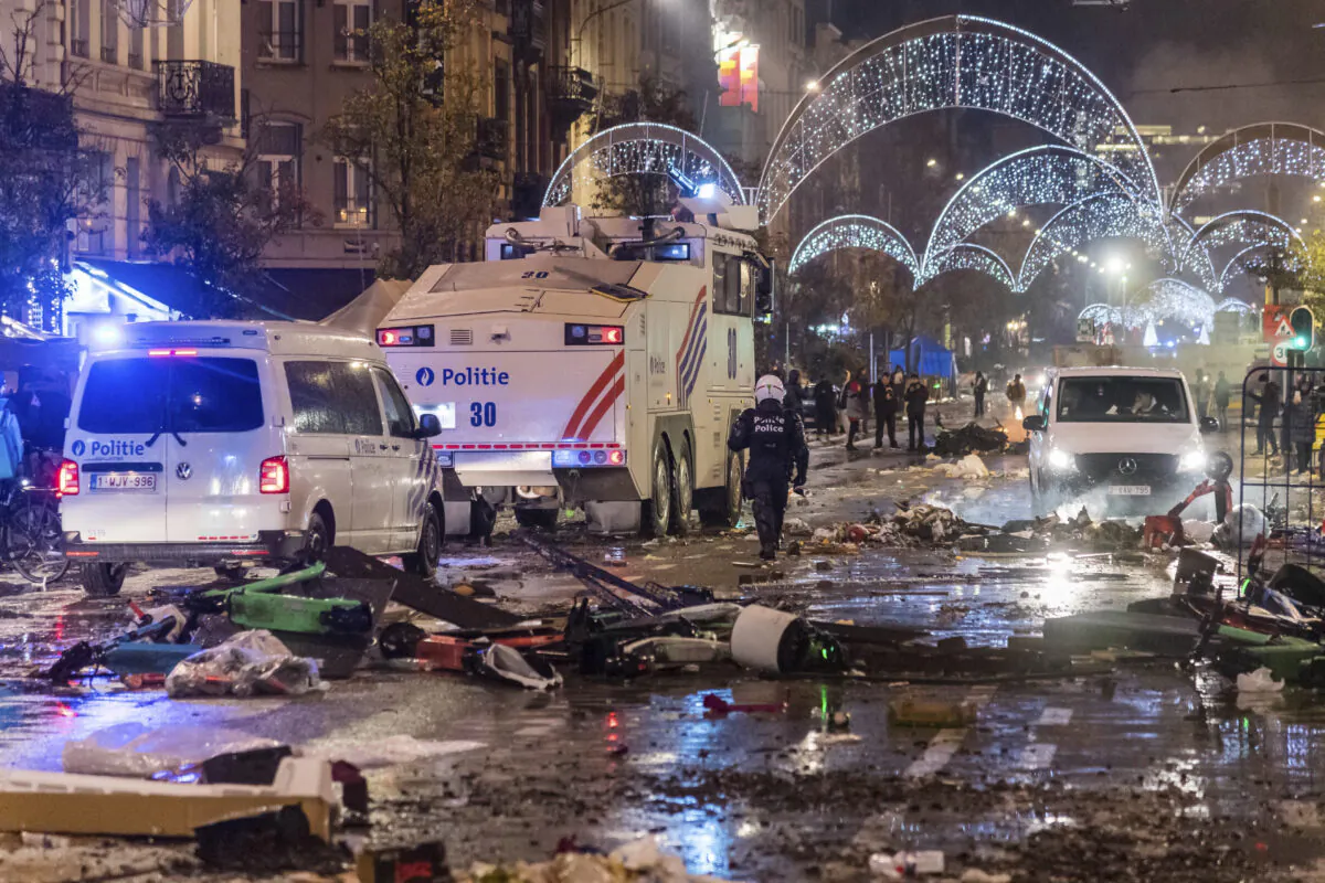 Police cars drive through a main boulevard in Brussels, as violence broke out during and after Morocco's 2–0 win over Belgium at the World Cup, in Belgium, on Nov. 27, 2022. (Geert Vanden Wijngaert/AP Photo)