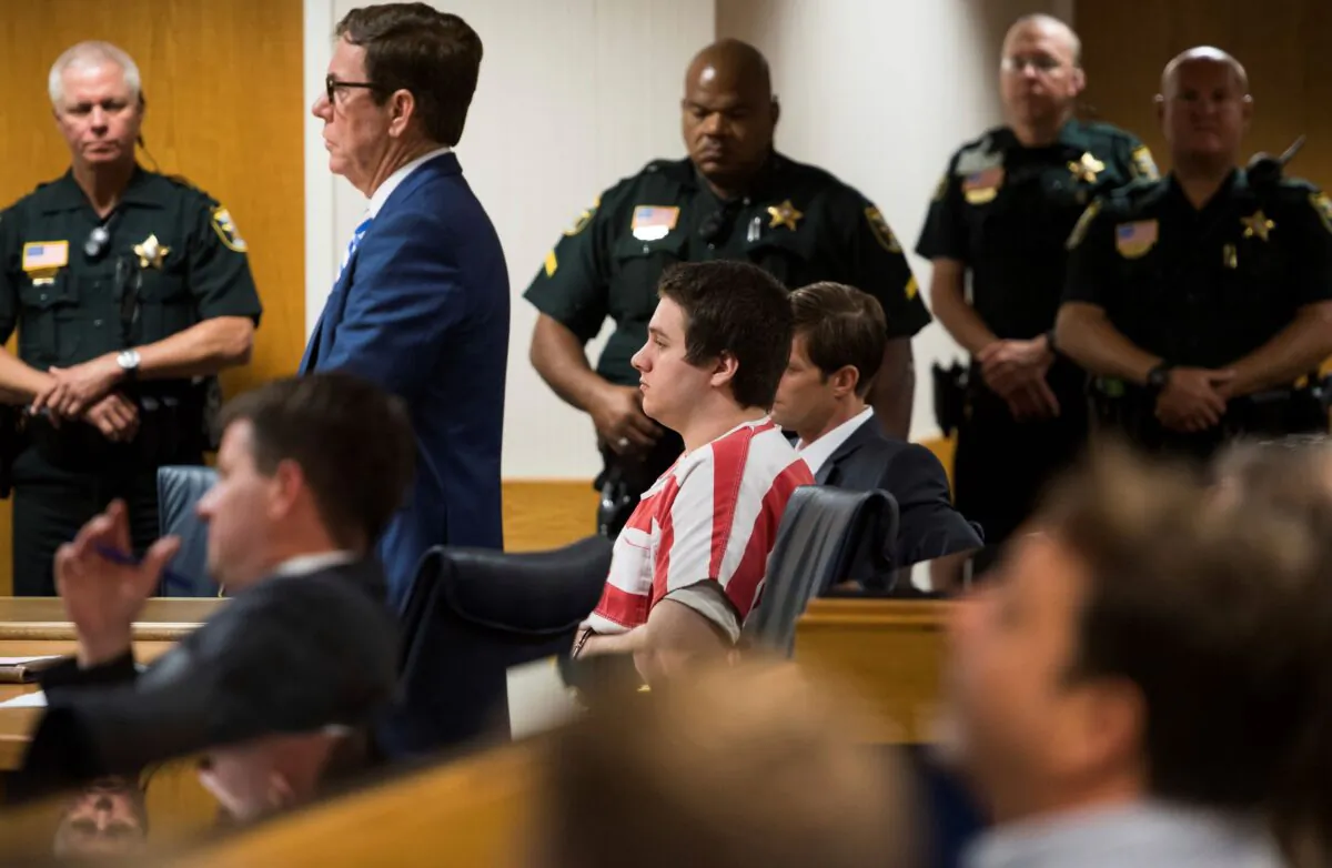 Austin Harrouff (C) wearing stripes, accused of brutally killing a Tequesta couple in 2016, appears at the Martin County Courthouse in Stuart, Fla., on Aug. 2, 2019. (Xavier Mascarenas/TCPalm.com via AP)