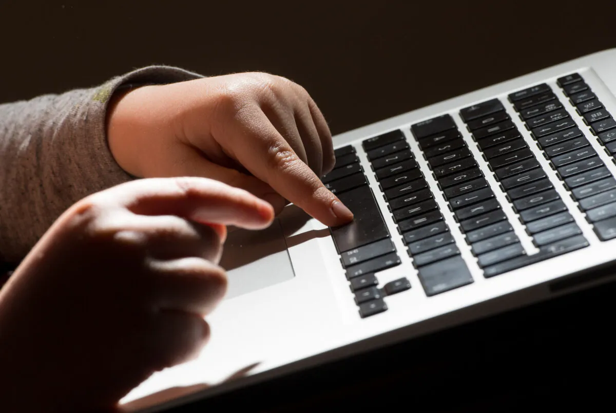 File photo of a child using a laptop computer, dated May 26, 2022. (Dominic Lipinski/PA Media)