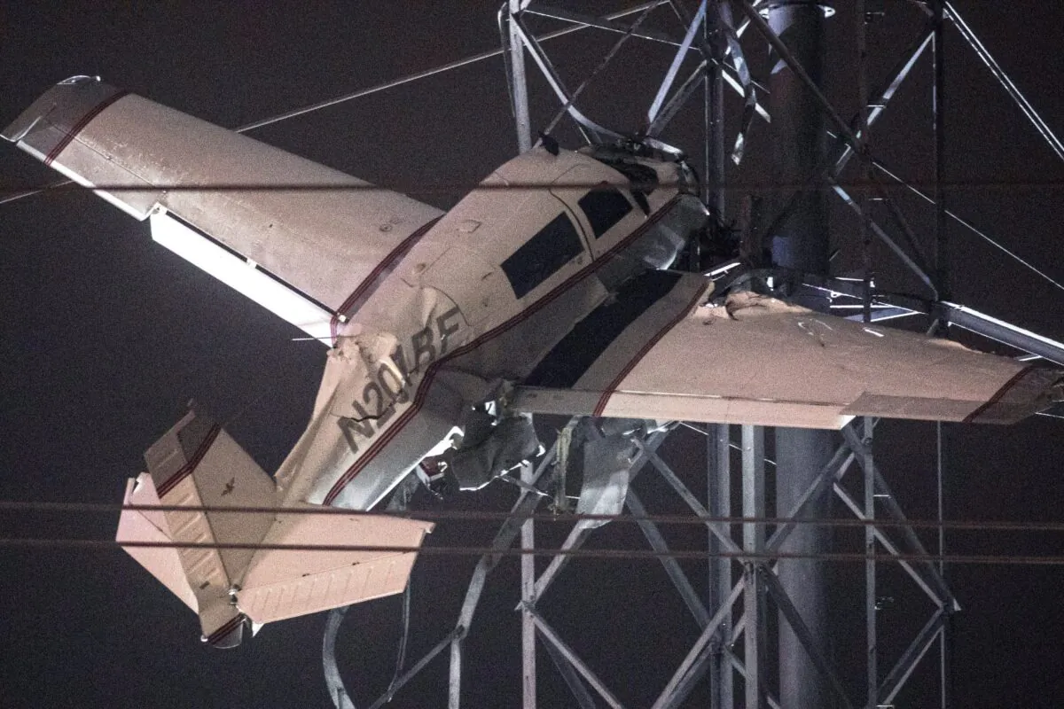 A small plane rests on live power lines after crashing, in Montgomery Village, a northern suburb of Gaithersburg, Md., on Nov. 27, 2022. (Tom Brenner/AP Photo)
