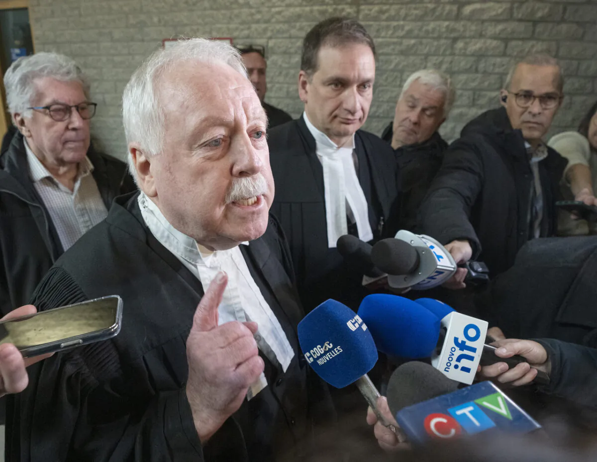 Defence lawyer Gary Martin (L) representing Yuesheng Wang, and Crown Prosecutor Marc Cigana speak to the media after a hearing at the courthouse in Longueuil, Quebec on Nov. 15, 2022. Former Hydro-Québec employee Wang is charged with economic espionage-related offences. (The Canadian Press/Ryan Remiorz)