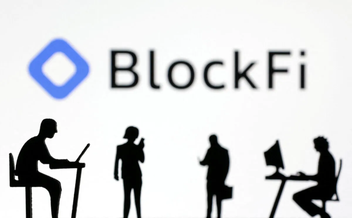 Figurines with smartphones and computers in front of the BlockFi logo in this illustration, on Nov. 28, 2022. (Dado Ruvic/Illustration/Reuters)