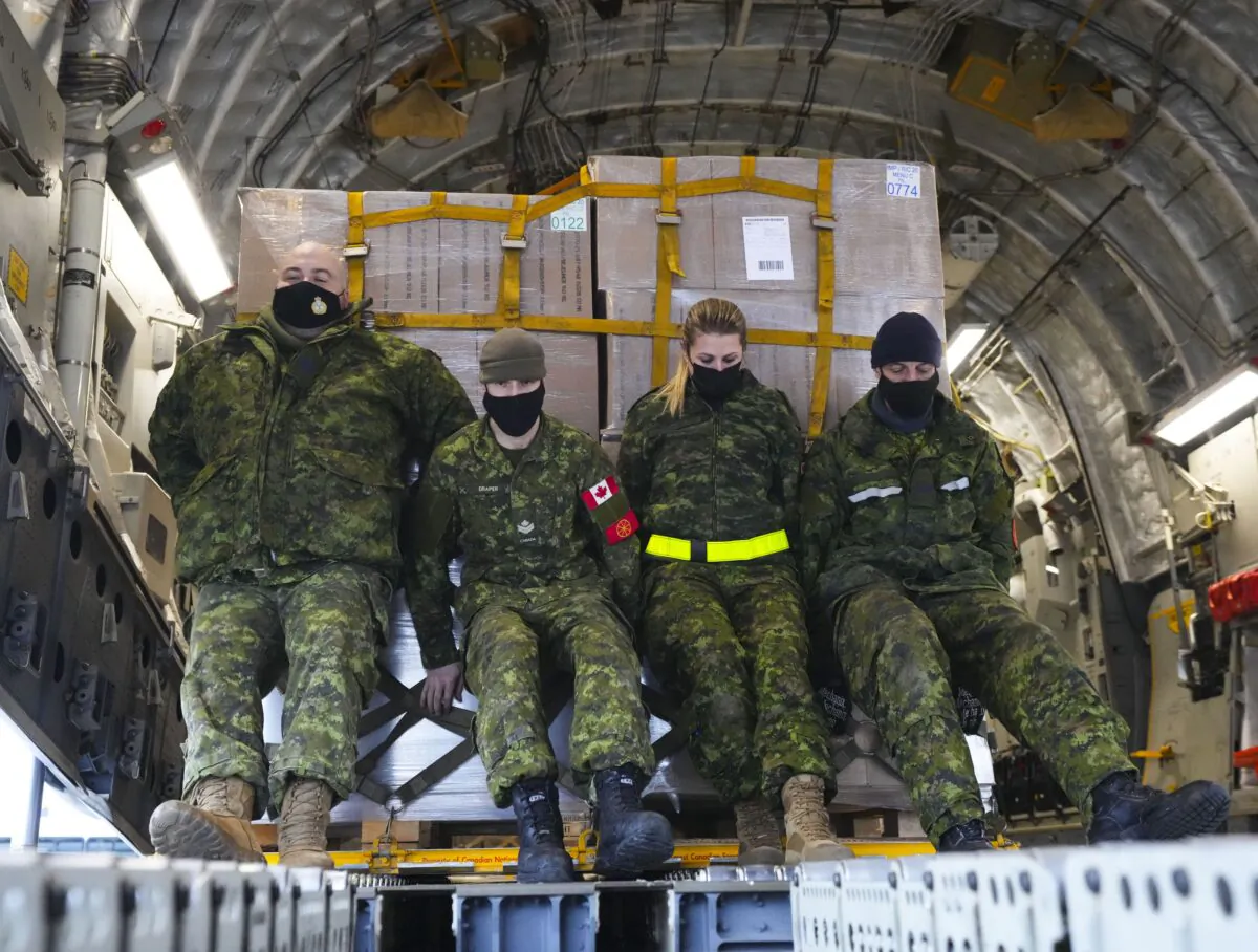 Royal Canadian Air Force personnel load non-lethal and lethal aid at CFB Trenton, Ontario on March 7, 2022. The cargo was bound for Ukraine via Poland. (Sean Kilpatrick/The Canadian Press)